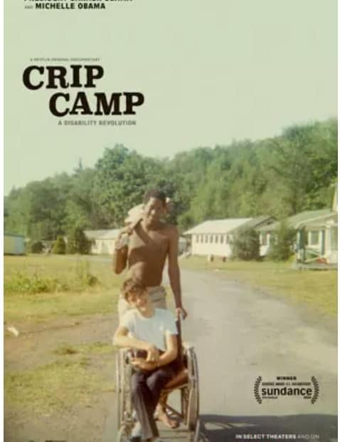 Movie poster CRIP CAMP: A DISABILITY REVOLUTION. Two young smiling teen boys together, one teen who is black, holding a guitar over his sholder, standing behind the other teen who is white, sitting in a wheelchair.