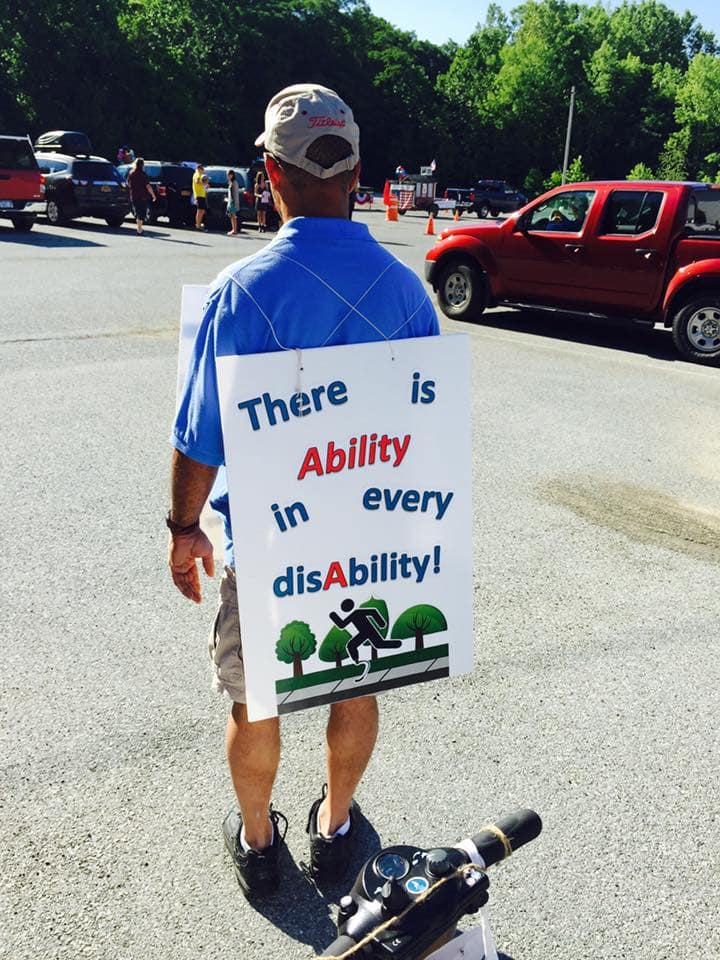 person with a big sign that says there is ability in every disability