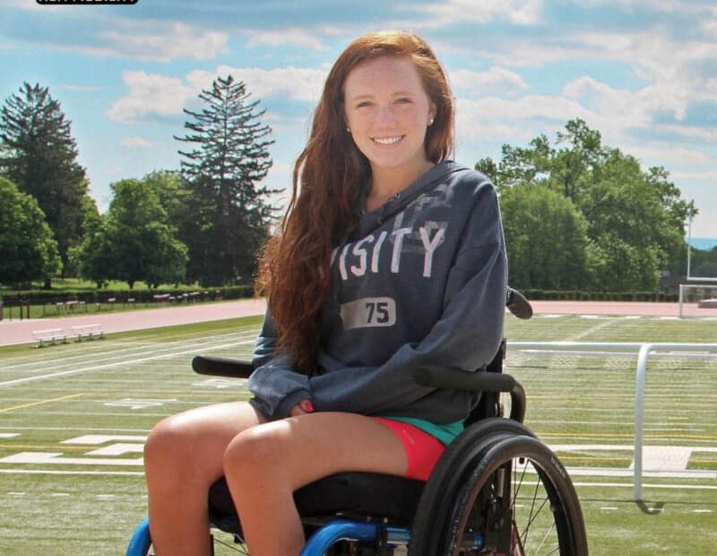 The magazine cover page showing a young woman in a wheelchair with a university t-shirt with the title saying From New Mobility Magazine and United Spinal Association Wheels on Campus a Guide to Wheelchair-Friendly Higher Education